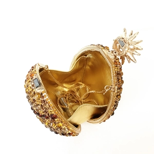 Luxurious pineapple-shaped crystal evening clutch with golden rhinestones and metal chain