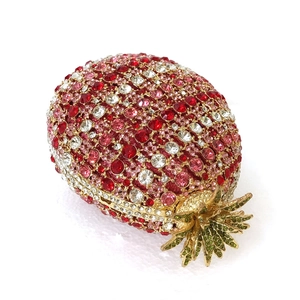 Detailed macro view of pineapple evening bag with red and green crystals