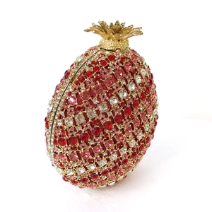 Detail of red crystal pineapple clutch bag with hollow out diamonds and gold crown clasp