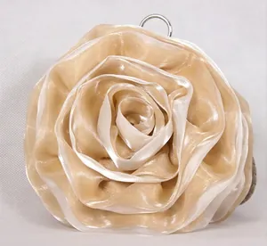 Macro detail of the champagne silk rose evening bag with a round silver metal handle