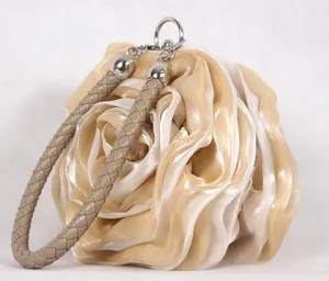 Detailed macro view of champagne silk ribbon rose texture on a luxury bridal evening clutch