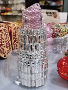 Macro shot of lipstick-shaped luxury clutch featuring pink and clear sparkling rhinestones