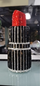 Detail of lipstick clutch evening bag featuring red black and silver rhinestones