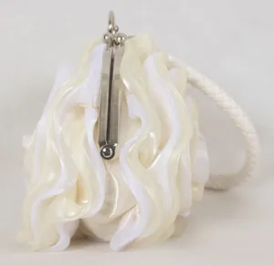 Side view of white satin evening clutch featuring 3D floral folds and silver metal clasp