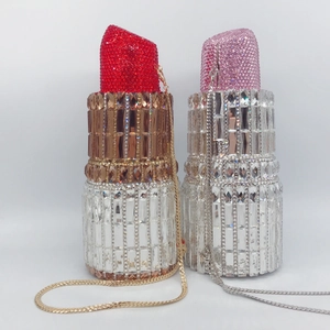 Detailed view of lipstick-shaped clutch bags with high-density rhinestones and chain strap