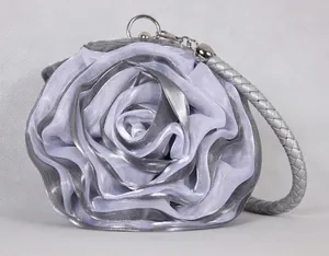 Detail of silver rose-shaped evening bag featuring layered 3D mesh fabric and metal rings