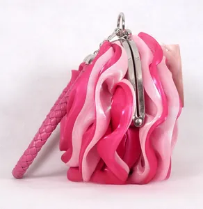Detailed close-up of pink satin 3D rose flower evening clutch with metal clasp