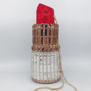 Detailed macro shot of a lipstick shaped evening clutch bag with sparkling crystals