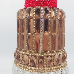 Detailed close-up of luxury lipstick evening bag with sparkling colorful rhinestones
