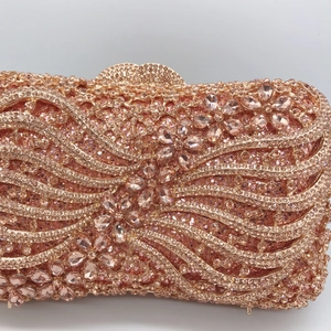 Sparkling rose gold evening clutch bag with diamond rhinestones and floral metal frame