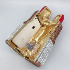 Top view of lipstick crystal clutch showing golden satin interior and smartphone capacity
