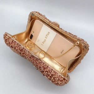 Elegant rose gold bow evening clutch with pink crystals and a fine gold chain strap