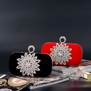 Elegant U-shaped velvet evening clutch with sparkling diamond floral embellishment