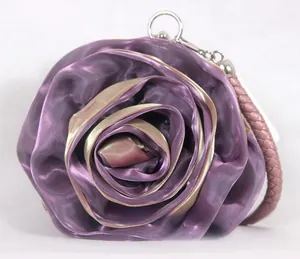 Detail of purple and gold satin rose evening bag showing petal layers and metal ring clasp