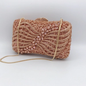 Detailed view of pink crystal rhinestones and wave pattern on evening clutch bag