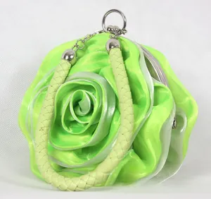 Detailed macro view of 3D neon green satin rose petal texture on evening bag