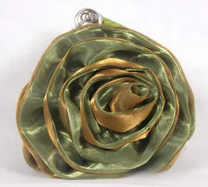Detail of multi-layered rose petal handbag in green and gold silk fabric with ring hook
