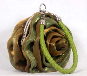 Detailed view of the layered rose petal fabric and silver metal clasp of the evening bag