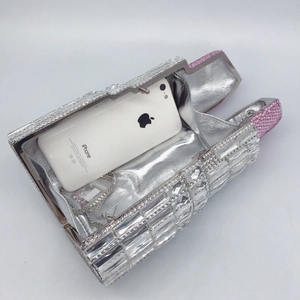 Lipstick-shaped evening clutch bag with sparkling crystals and silver chain strap