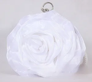 Detailed view of layered white satin rose petals with elegant silver metal handle