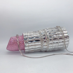 Detailed view of pink and clear rhinestones on luxury lipstick-shaped evening clutch bag