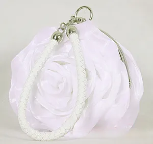 Detail of white satin 3D rose evening bag with leather handle and metal clasp closure