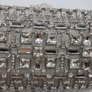 Luxurious silver evening clutch bag with geometric crystal patterns and sparkling rhinestones