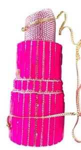 Detailed view of lipstick shaped evening clutch with hot pink crystals and gold chain strap