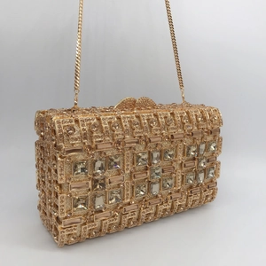 Elegant gold rhinestone evening clutch bag with geometric crystal patterns and chain strap