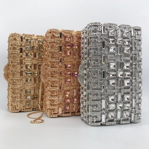 Close-up of luxury evening clutch bags with geometric crystals in gold and silver