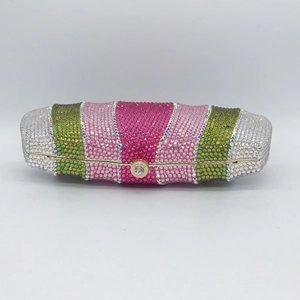 Detailed view of luxury evening clutch featuring colorful crystal vertical stripes and metal clasp