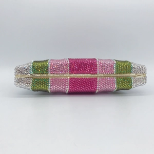 Detailed view of colorful rhinestones on a luxury evening clutch bag with gold metal frame