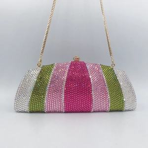 Macro shot of colorful crystals and vertical stripe pattern on luxury clutch bag