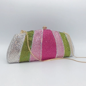Detail of colorful striped rhinestones and gold clasp on luxury evening clutch bag