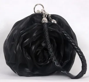 Detail view of large 3D satin rose flower evening bag with black woven handle