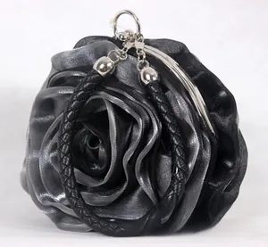 Close-up of layers of black and silver silk petals on a rose-shaped evening bag