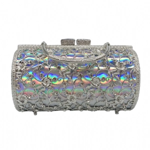 Detailed close-up of hollow silver evening bag with rhinestones and holographic lining