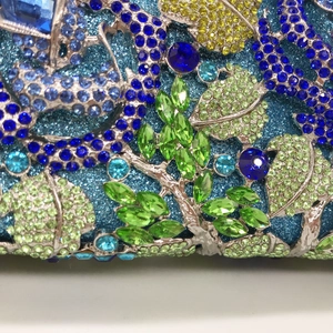 Elegant crystal floral evening clutch with blue sequins and colorful rhinestone vine patterns