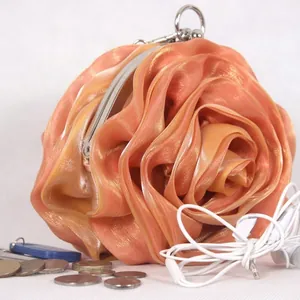 Elegant champagne satin evening bag featuring a 3D rose flower design and metal clasp