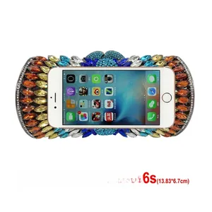 Detailed comparison of colorful rhinestone evening clutch with iPhone for size reference