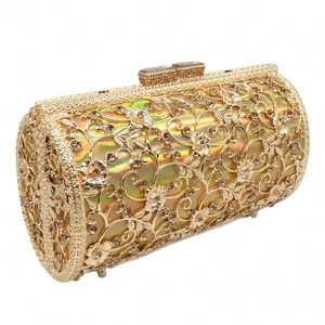 Macro detail of golden镂空 metal clutch with sparkling rhinestones and colorful lining