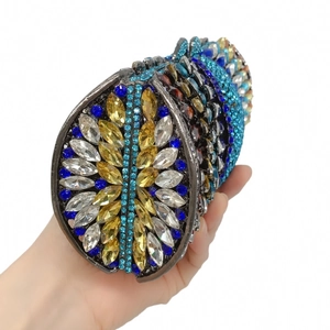 Close-up of gradient blue and gold rhinestones on a metal frame evening clutch bag