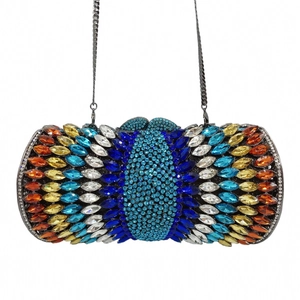 Detailed macro view of vibrant peacock feather rhinestone pattern on luxury dinner clutch