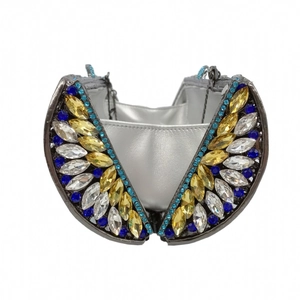 Detail of evening clutch bag featuring intricate multicolored rhinestone wings and silver interior