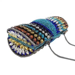 Detail of colorful rhinestones on a cylindrical clutch bag with a metal chain strap