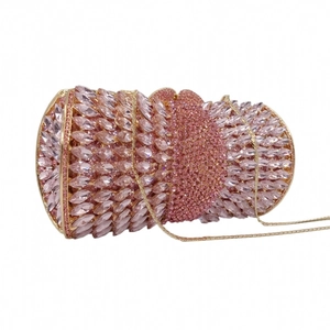 Macro detail of luxury evening clutch bag with sparkling pink crystals and gold chain