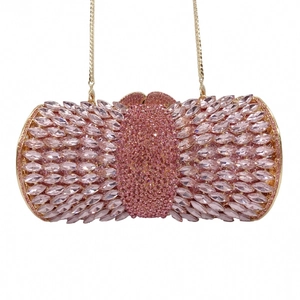 Macro view of pink crystal rhinestones and gold metal frame on an evening clutch bag