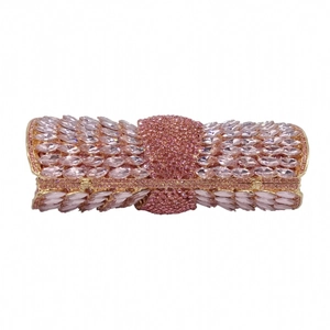 Detailed close-up of pink crystal evening bag with intricate bow tie design and gold frame