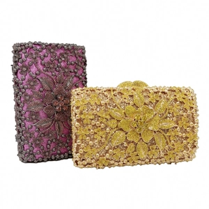 Detailed macro of gold and purple evening clutch bags with crystal flowers and metal clasps