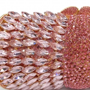Macro detail of pink marquise and round rhinestones on an elegant evening clutch bag